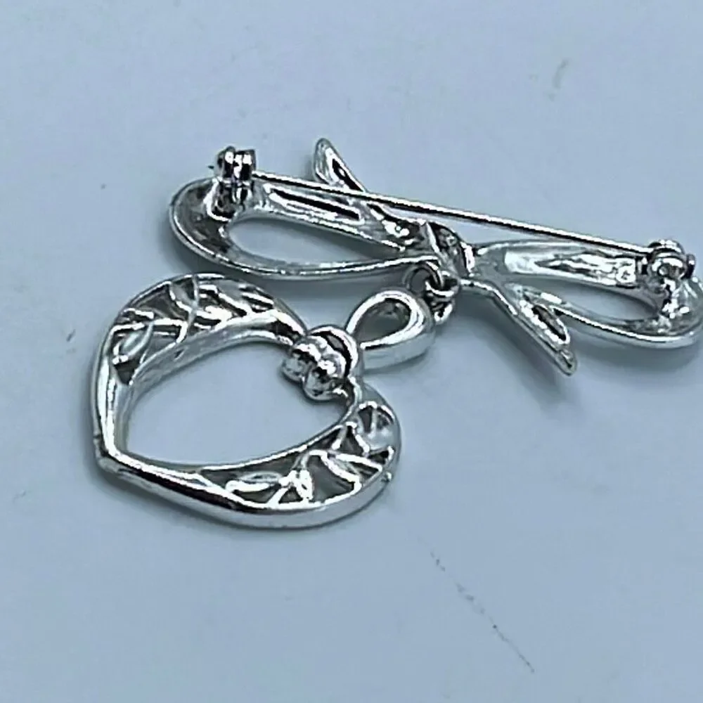 Vintage stylized bow and dangle heart brooch